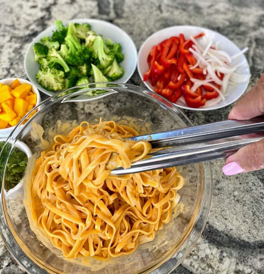 Toss the noodles in the sauce first