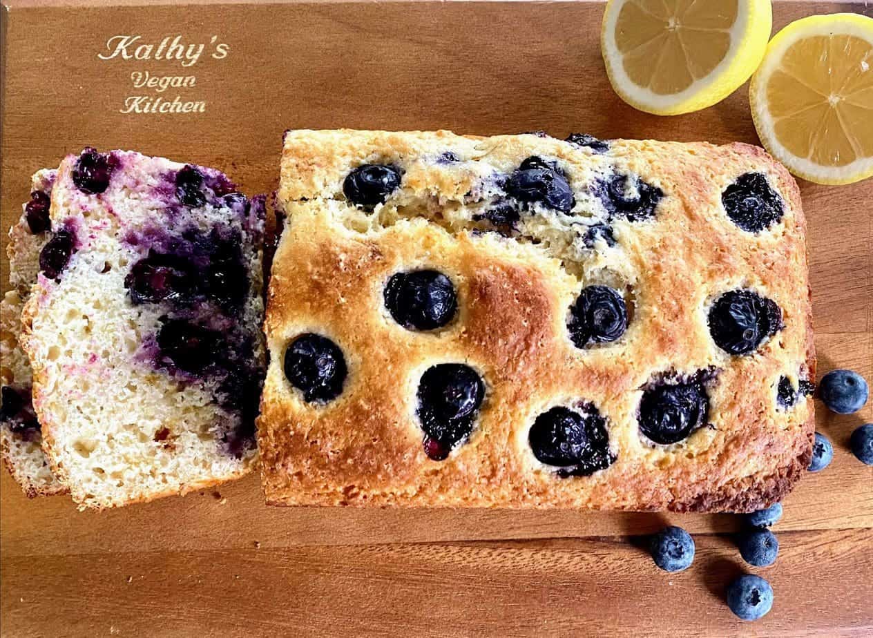 lemon blueberry bread sliced on a cutting board
