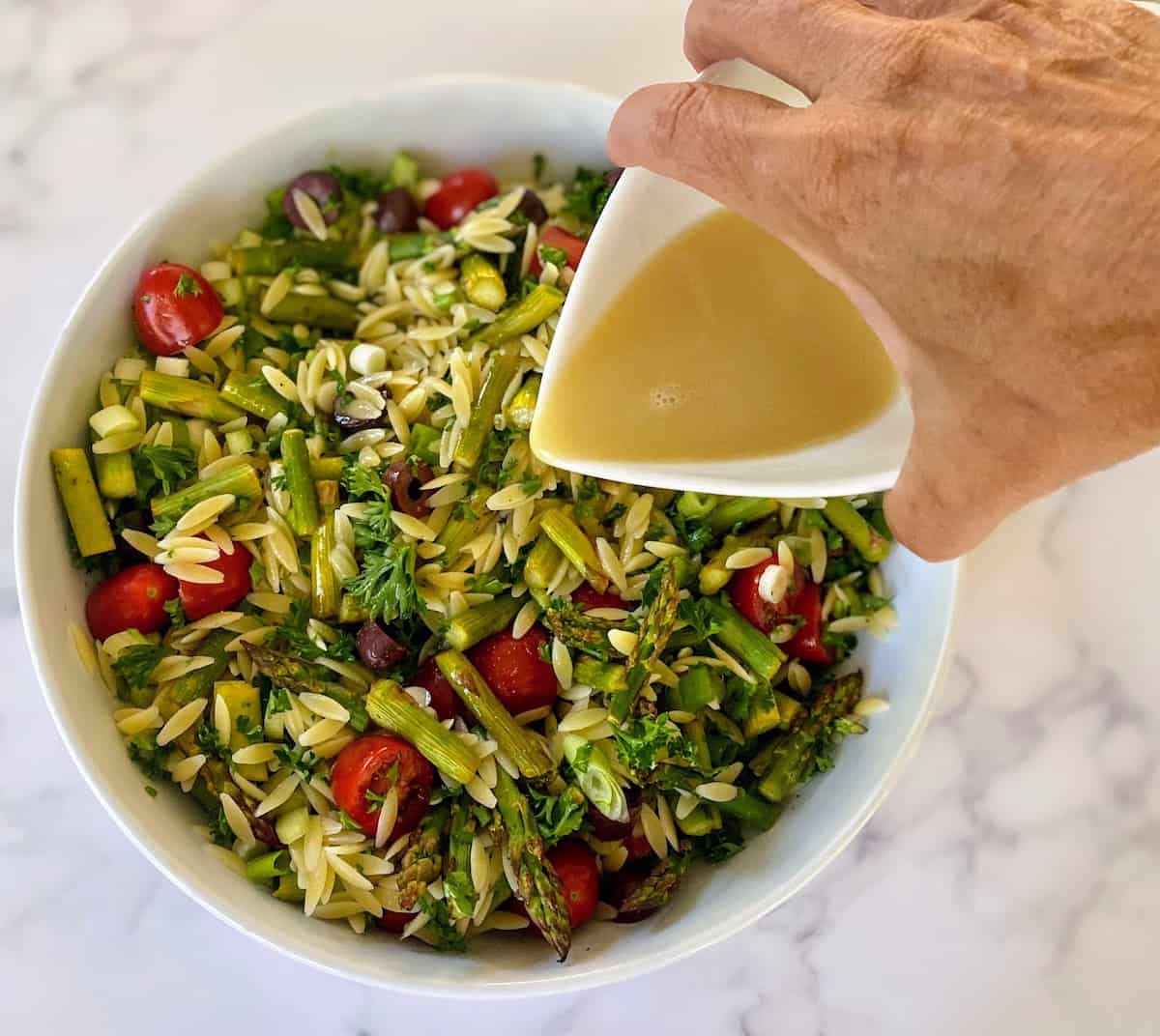 Pour dressing over mixed asparagus salad