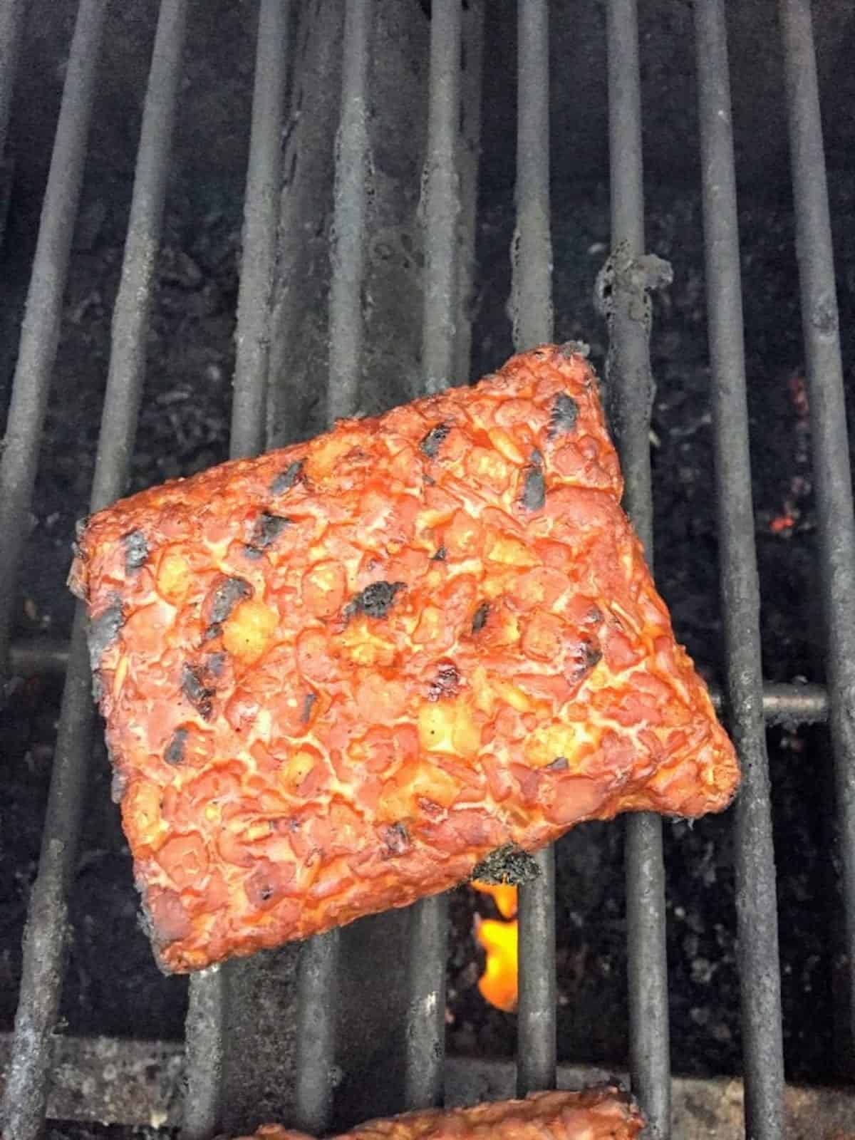 Tempeh grilling on the grill grates
