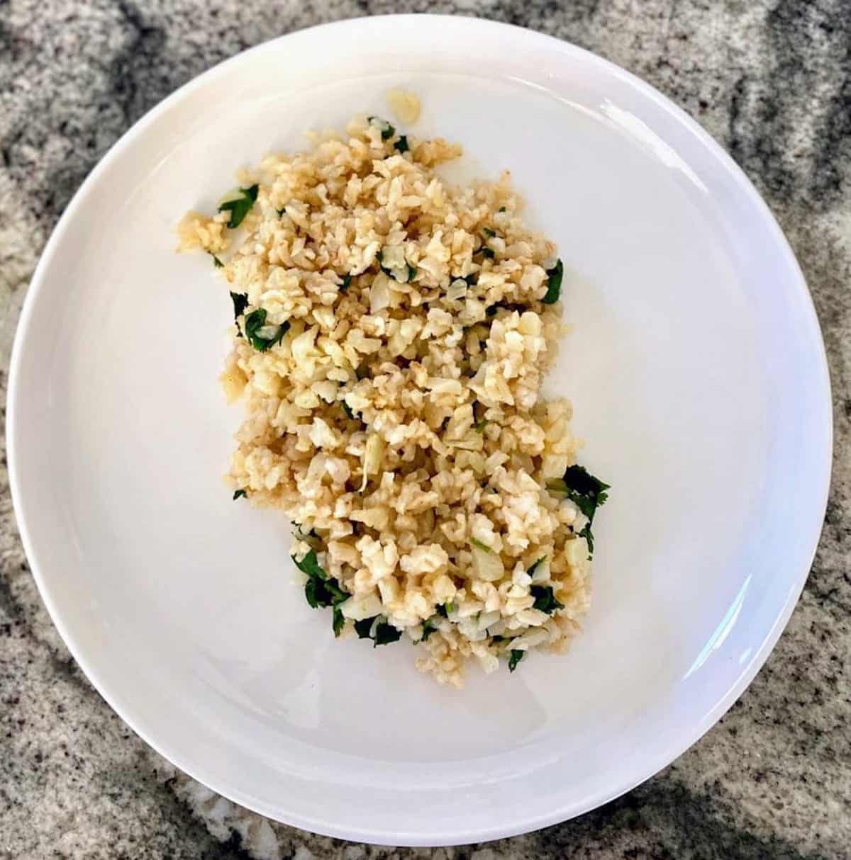 Cauliflower rice with lime and cilantro in a bowl on the table
