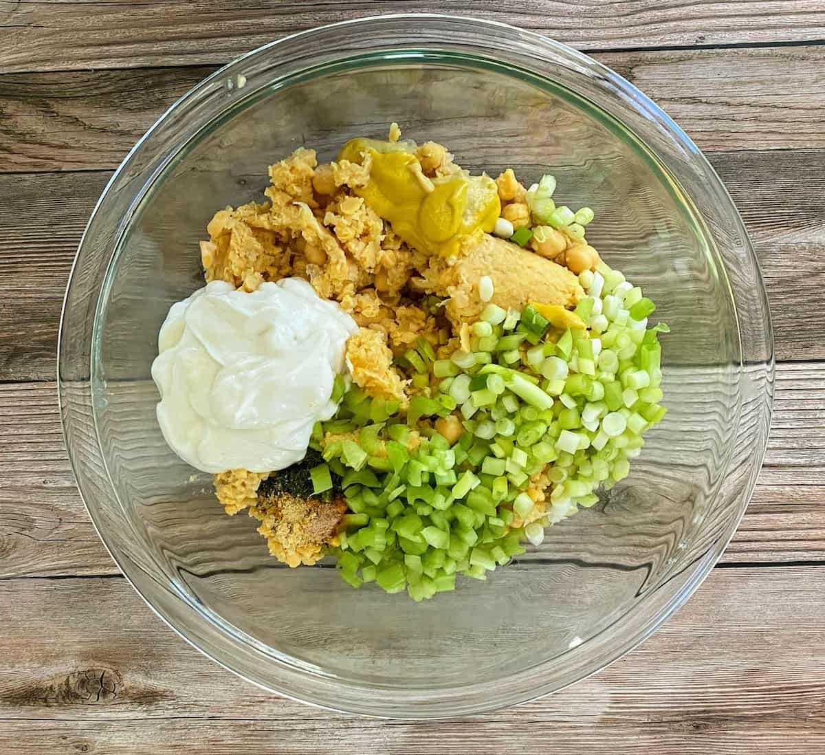Egg salad ingredients in a bowl on the table