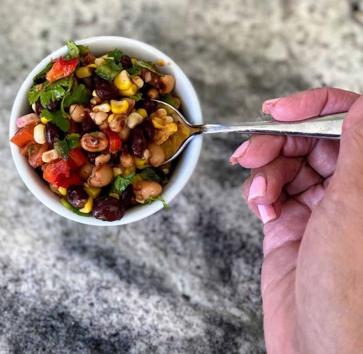 Cowboy caviar is served in a small bowl as a side dish