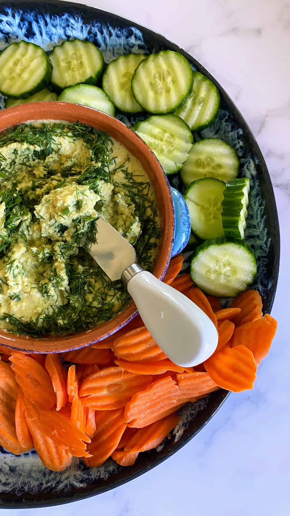 Almond cheese served on a vegetables tray on a table 