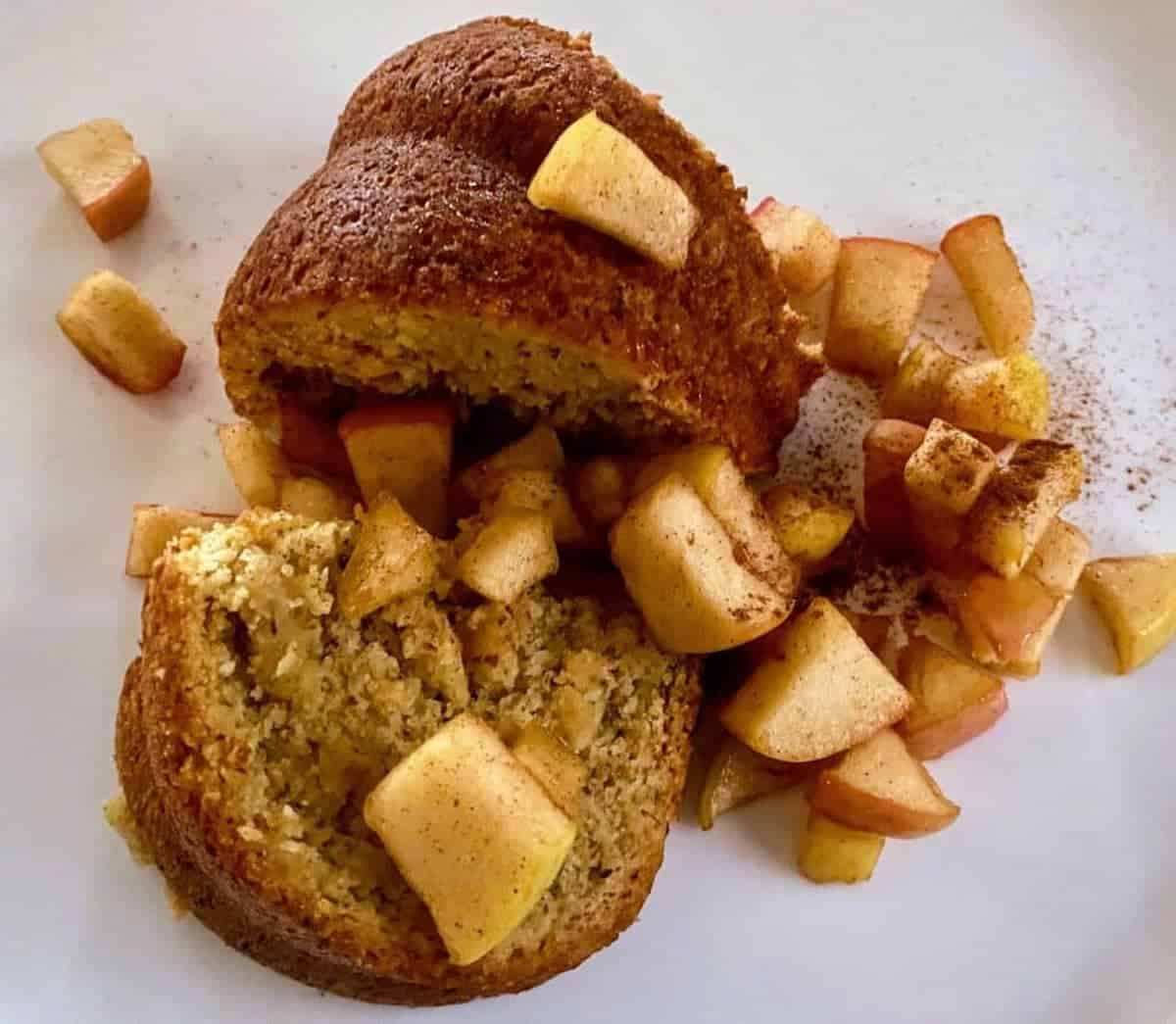 Vegan apple cider donut cake with apple topping on a plate.