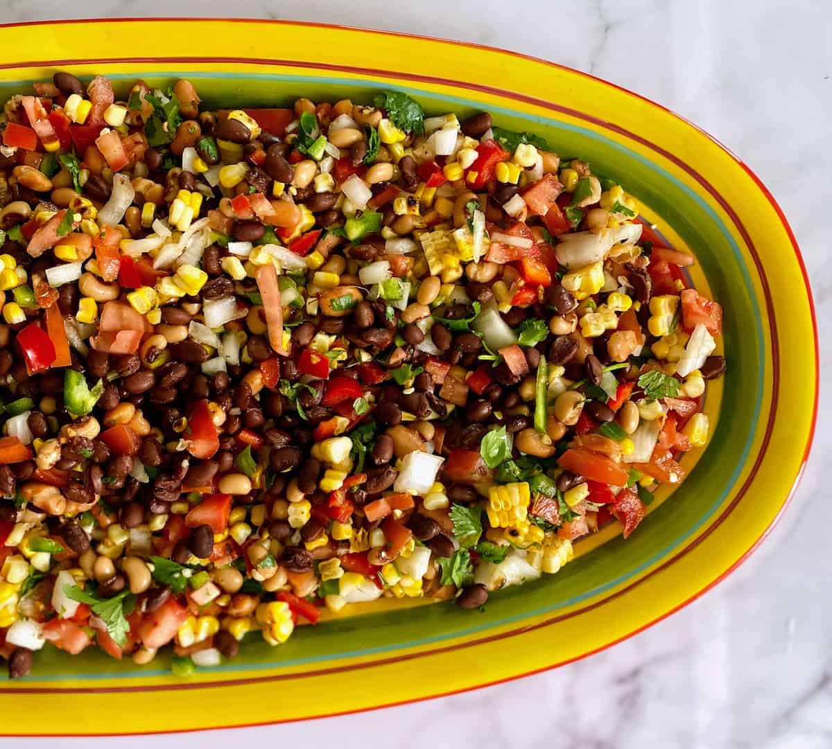 cowboy caviar on a serving platter on the table