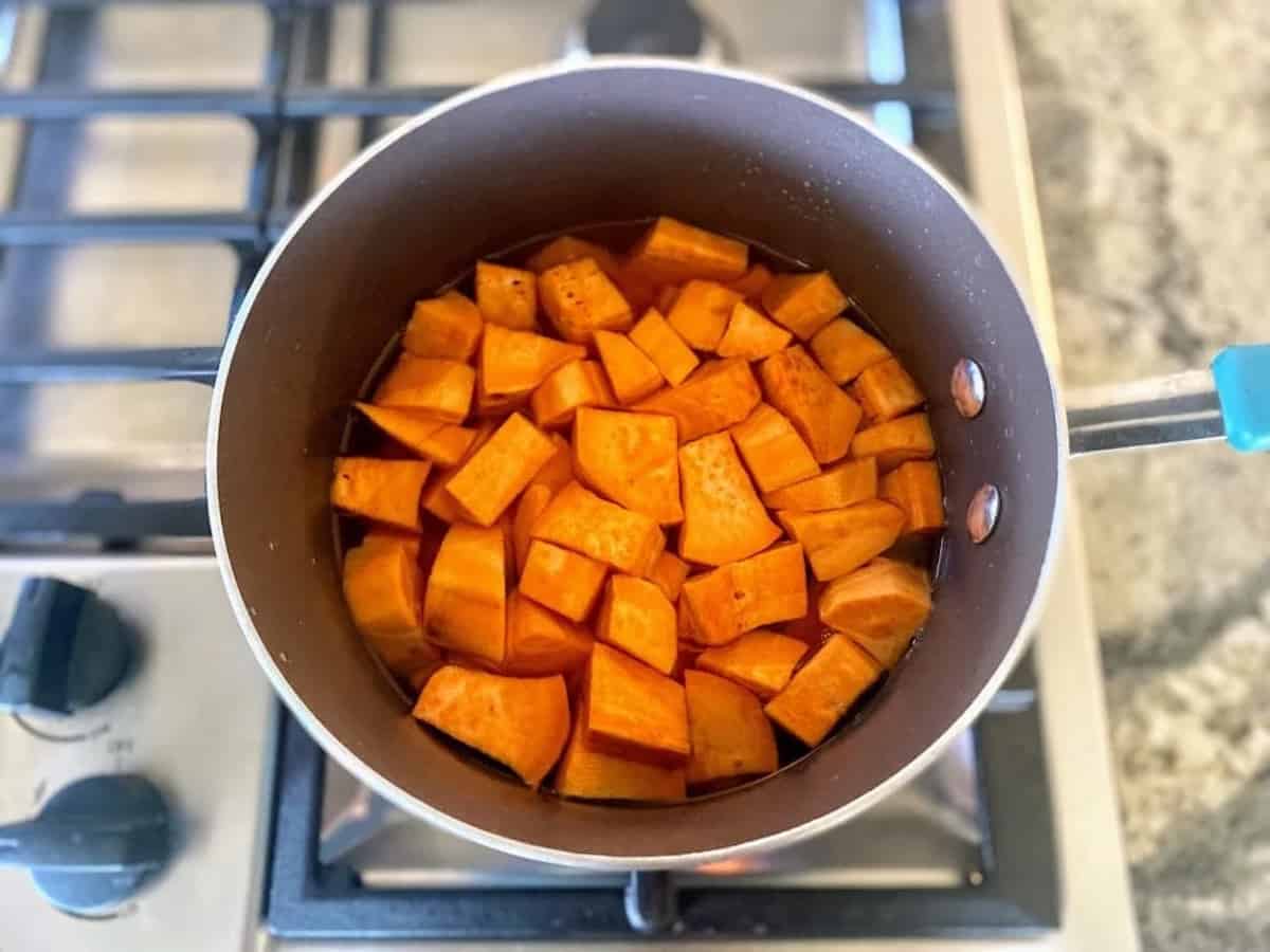 Sweet potatoes cooking in a pan on the stove