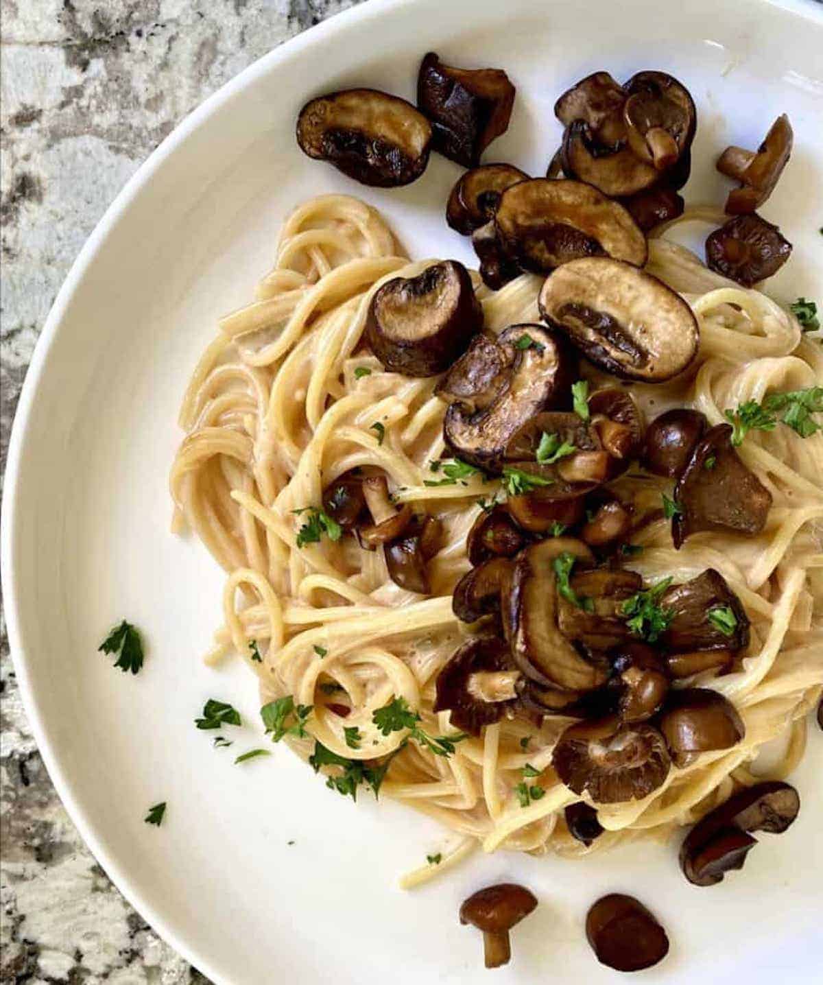 Creamy Mushroom pasta recipe on a plate served with parsley garnish.
