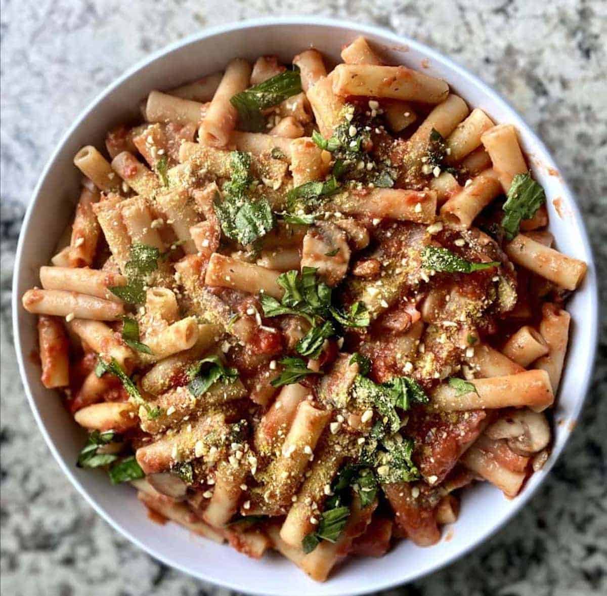 Creamy tomato pasta in a bowl on the counter