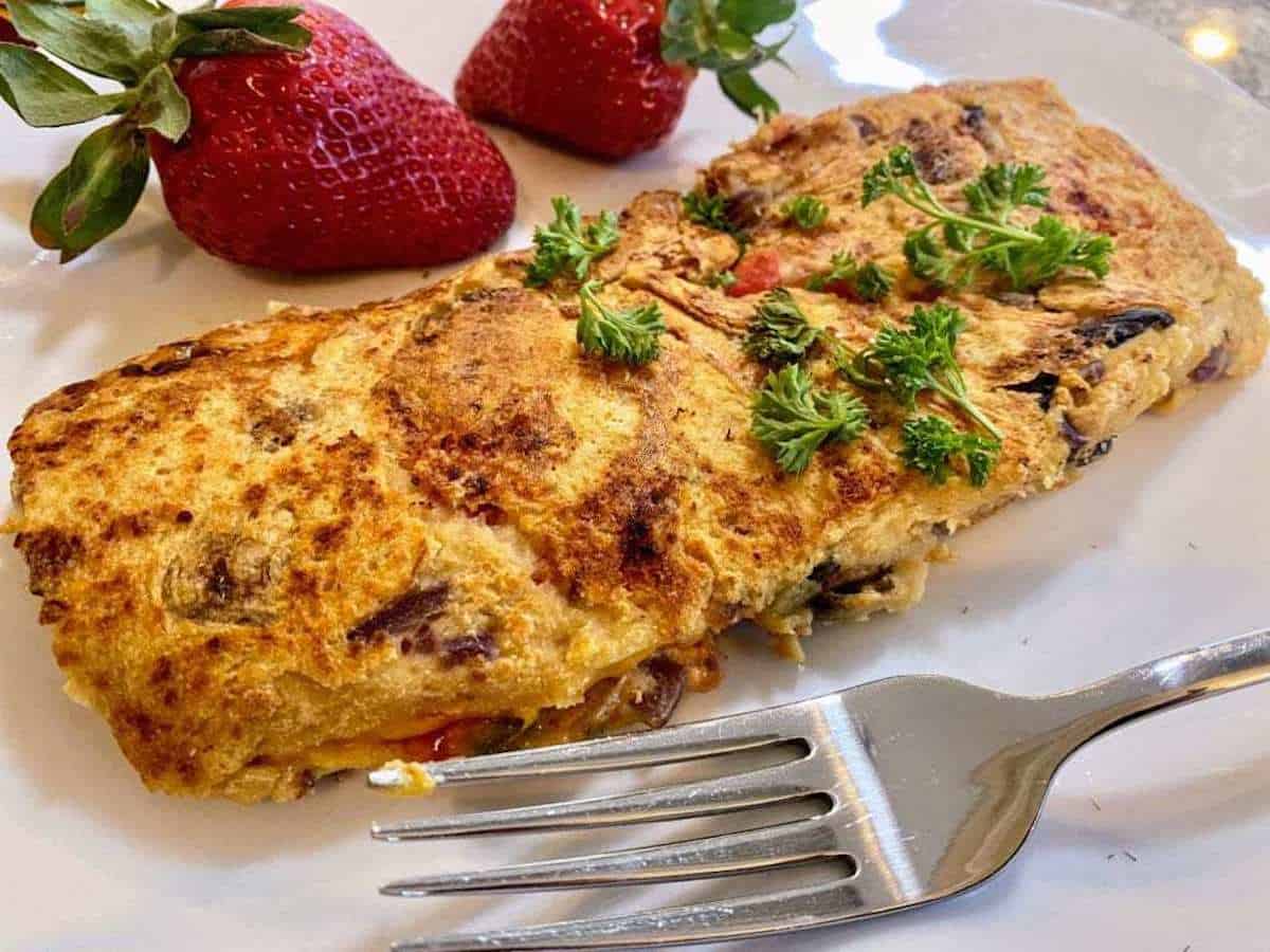 Chickpea omelette recipe A plate of chickpea omelette served with strawberries.