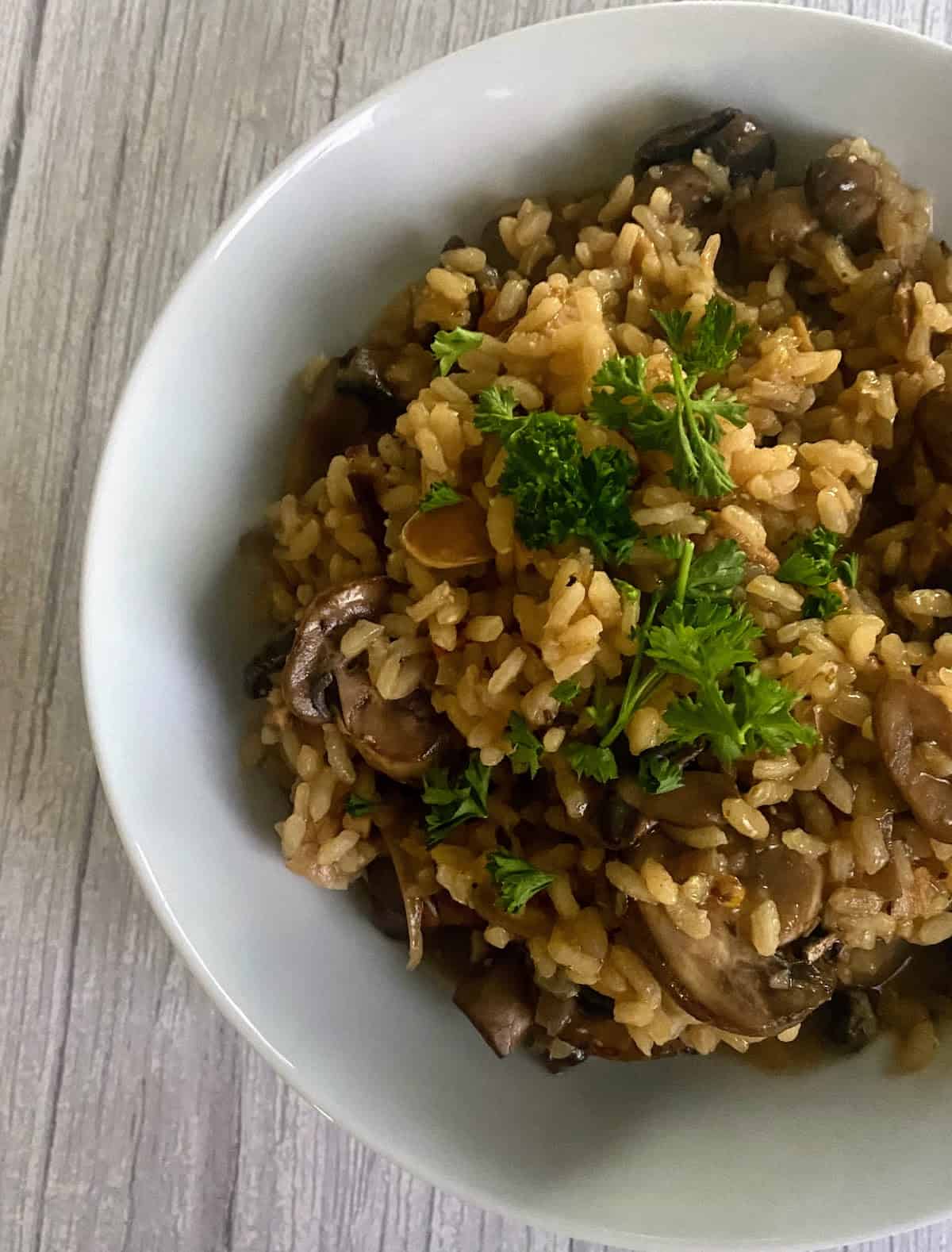 Vegan mushroom risotto in a bowl on the table.