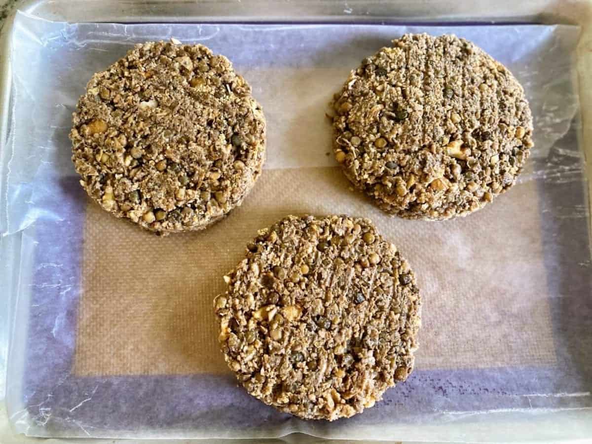 Formed veggie burger patties on a baking sheet.