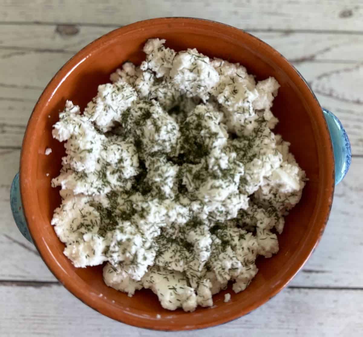 Tofu feta cheese in a bowl on the counter. 