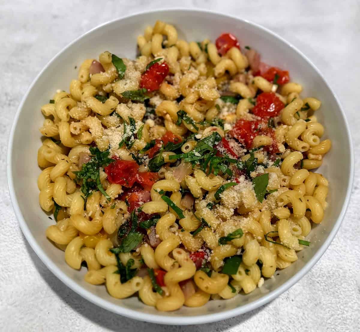 Vegan Bruschetta pasta in a bowl on the table. 