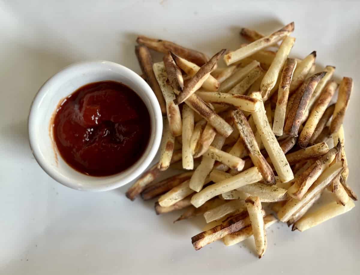 Fries on a plate with ketchup. 