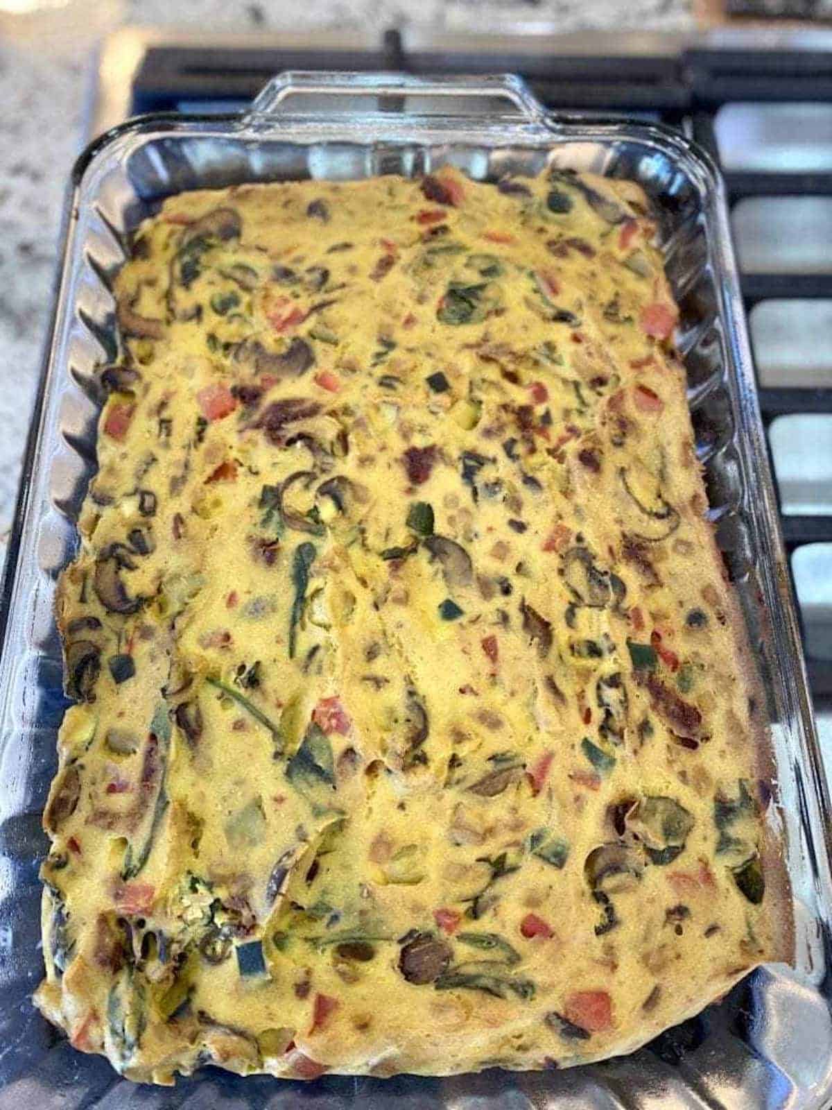 Cooked vegan breakfast casserole in a pan on the counter, cooling