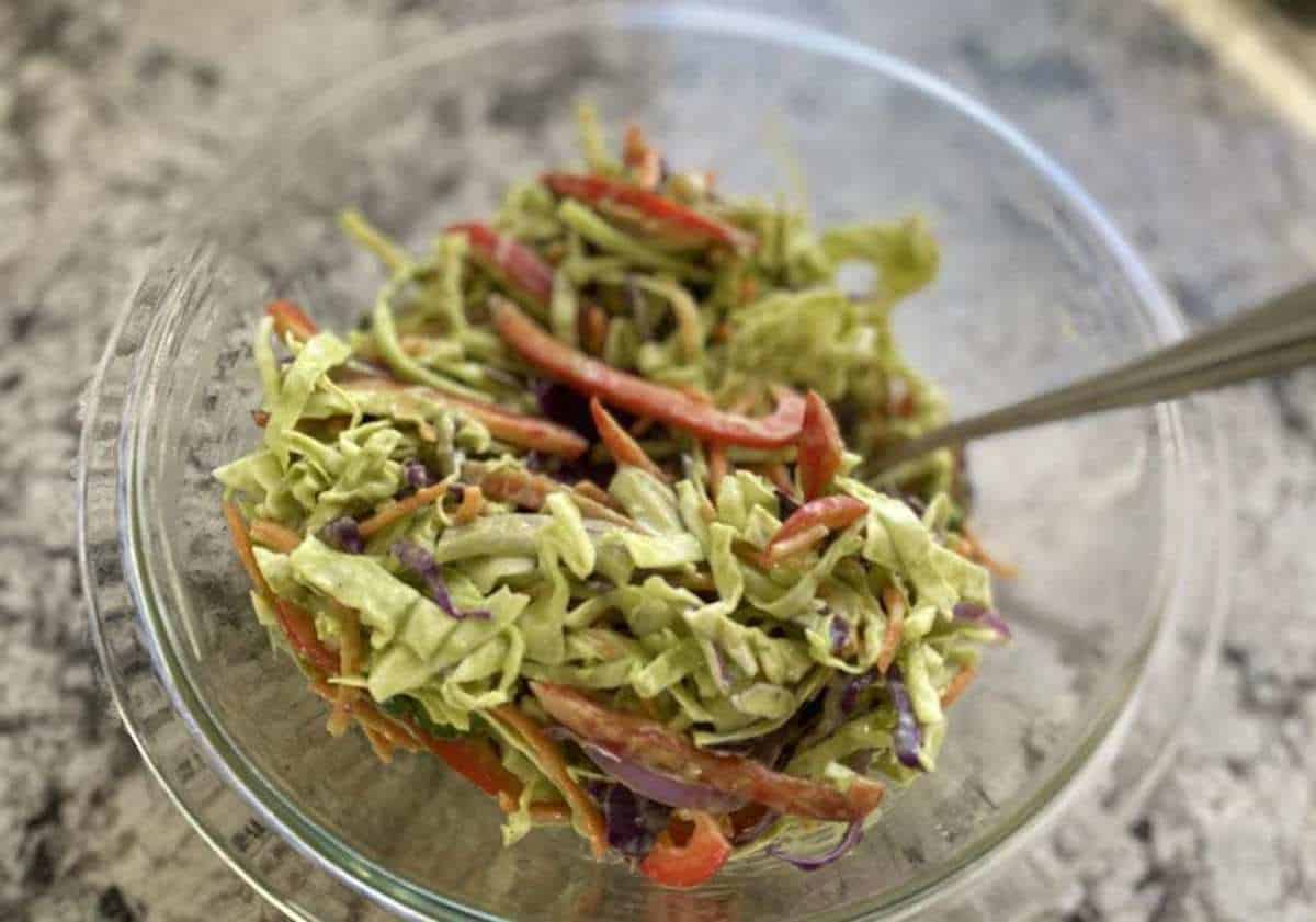 Vegan Coleslaw Recipe I am stirring the ingredients into teh coleslaw.