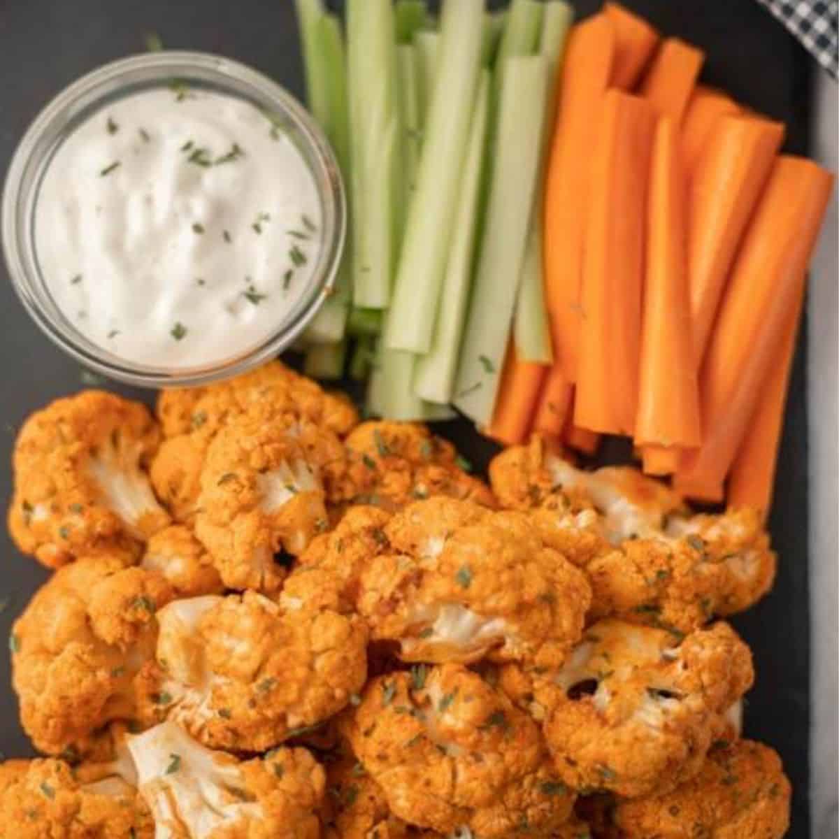Buffalo cauliflower wings with carrots, celery, and vegan ranch dressing.