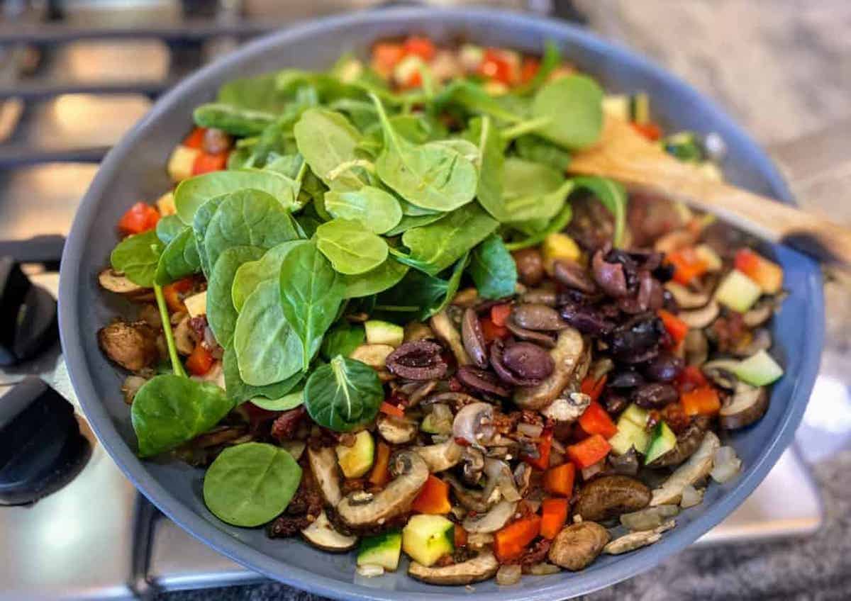 I am cooking the vegetables in a pan on the stove. 