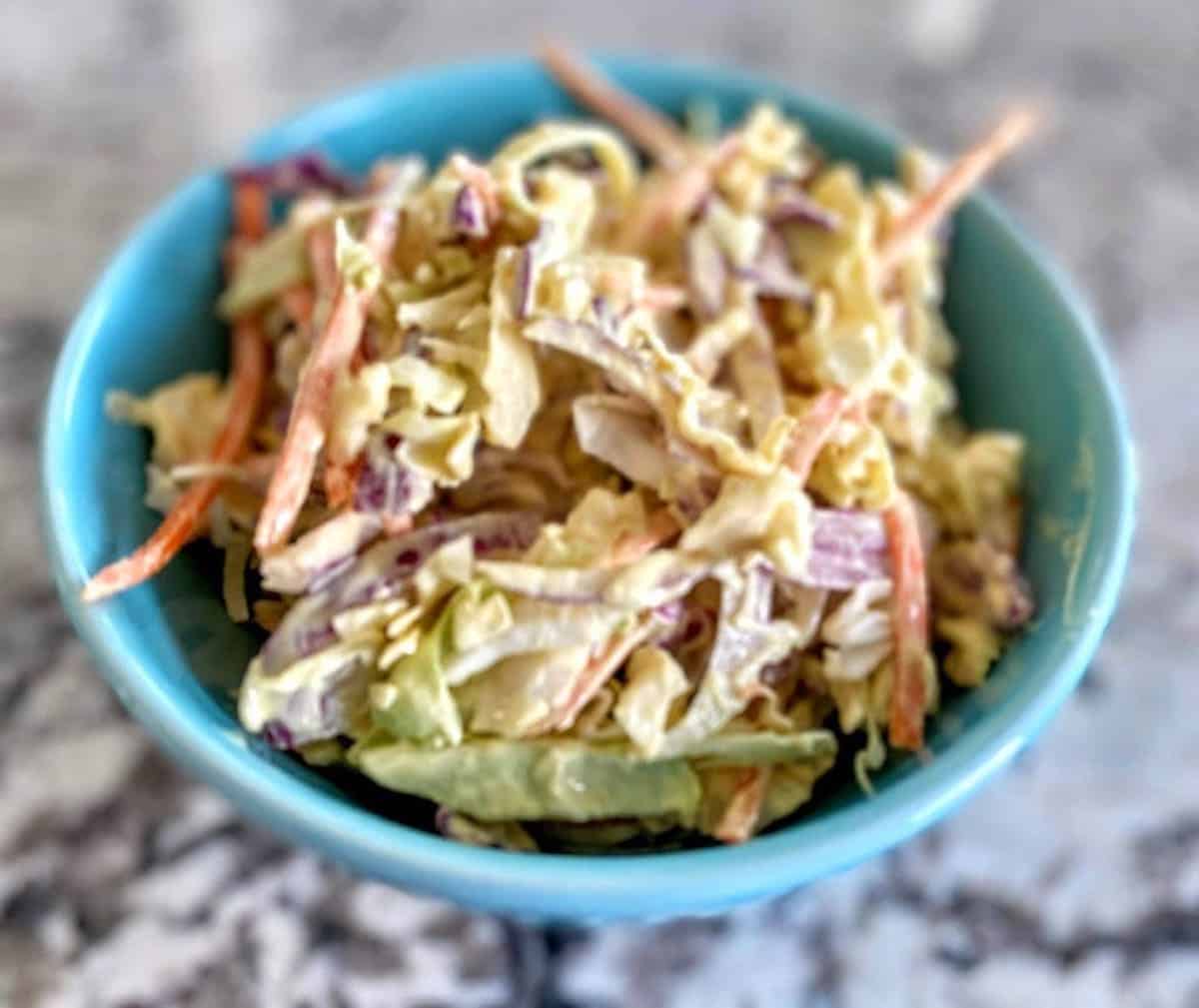 Vegan creamy coleslaw recipe in a bowl on the table.