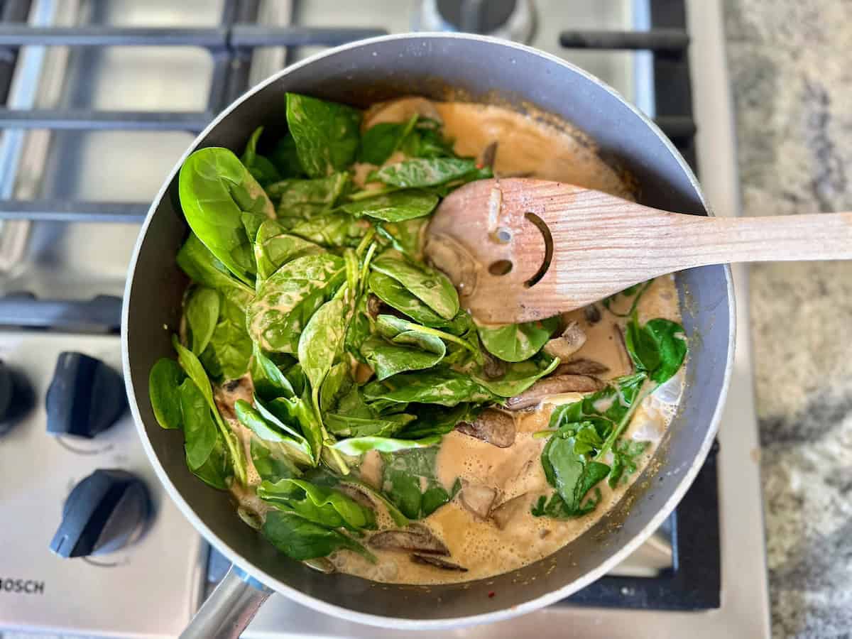 I added butter beans and spinach to the pan on the stove. 