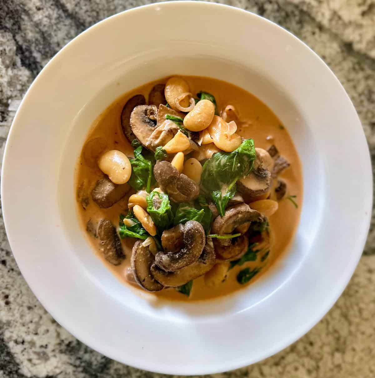 Butter bean curry recipe in a bowl on the counter.