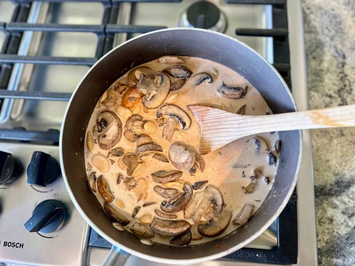 I added coconut milk and curry paste to the pan of mushrooms on the stove. 