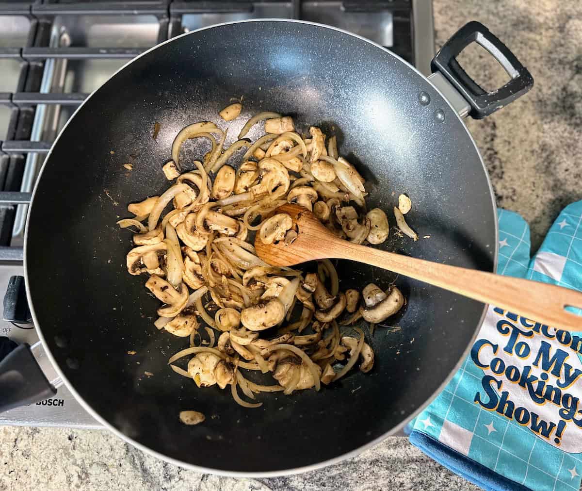 I am sauteing the garlic onions and mushrooms in a wok on the stove.,,